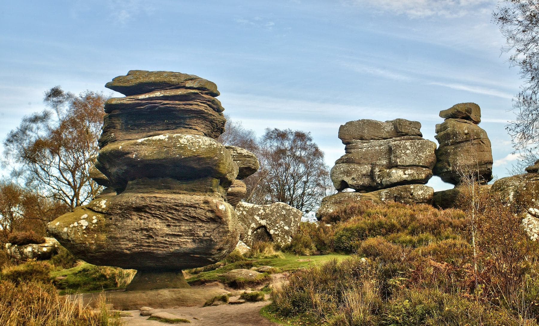 Stacked gritstone towers at Brimham Rocks rising from autumn bracken and heather.