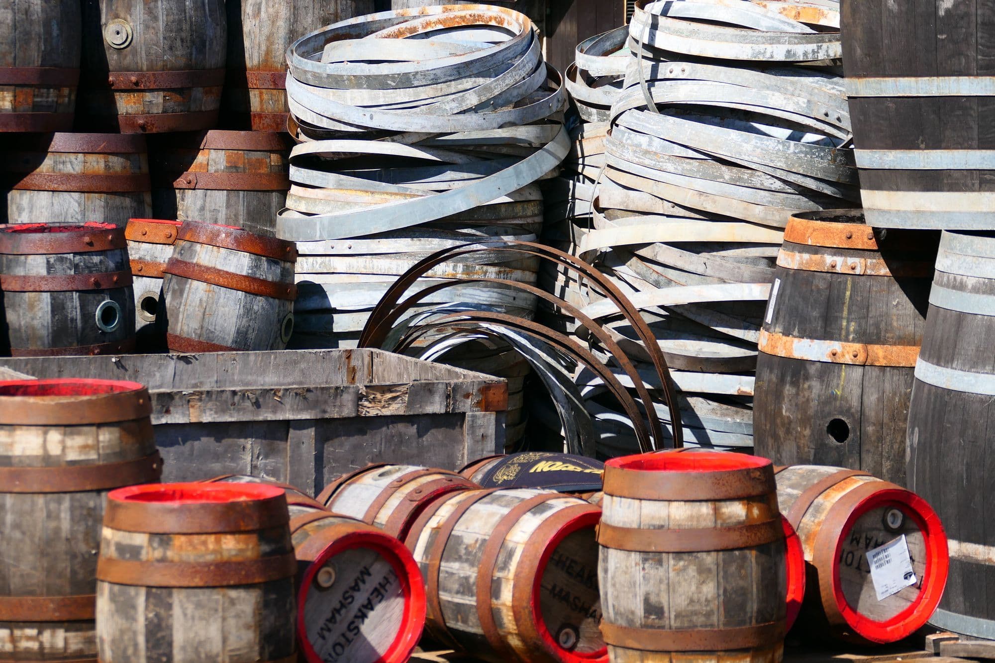 Oak casks and stacked iron hoops in a Masham brewery yard.